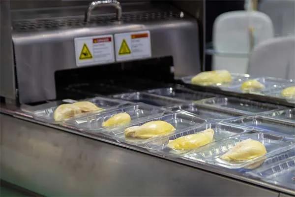 Food being packaged by machine Food being packaged by machine